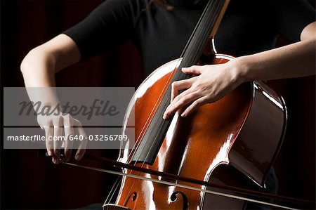 Close-up of young woman playing cello