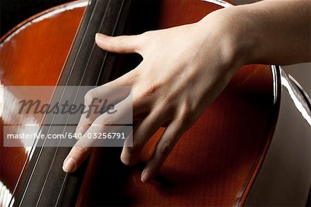 Close-up of young woman playing cello