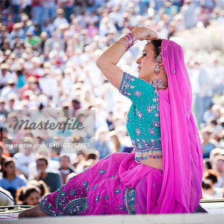 USA, Utah, Spanish Fork, mid adult dancer in traditional clothing performing on stage