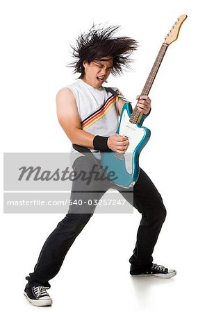 Young man playing electric guitar