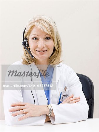 Mature woman talking on headset, studio shot