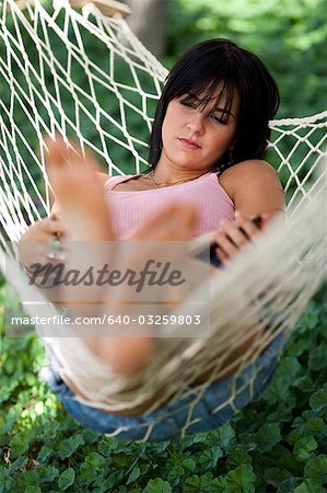 Woman sleeping in a hammock