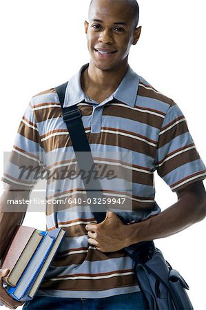 Teenage boy with bookbag and books