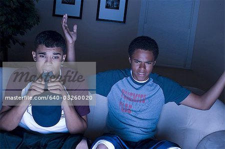 Two teenage boys eating snacks