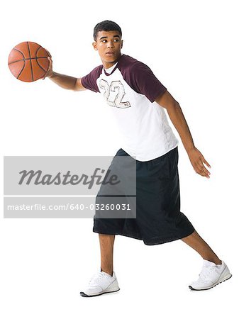 Teenage boy dribbling a basketball