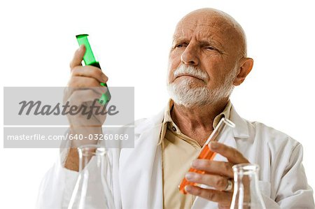 Scientist with chemicals in test tubes and beakers