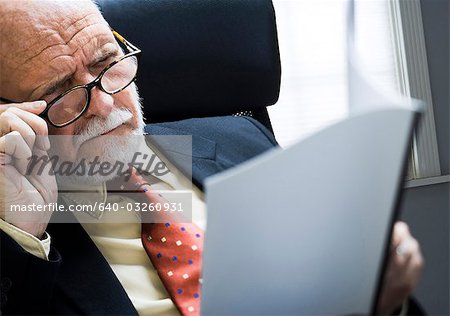 Closeup of businessman reading report