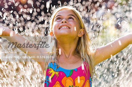 Girl in sprinkler