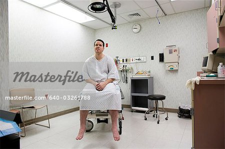 Male patient waiting on examining table