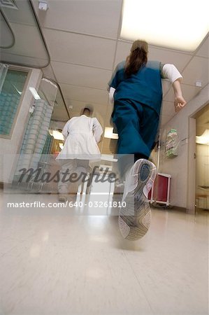 Doctor and nurse rushing through corridor