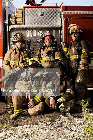 Group portrait of firefighters and fire engine