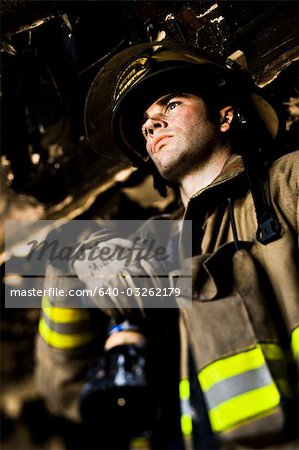 Portrait of a firefighter with fire hose