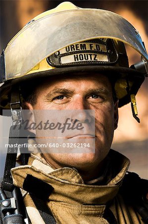 Portrait of a firefighter with fire in background