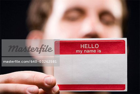 Man holding blank name tag