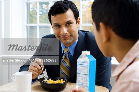 Man and boy at breakfast table smiling