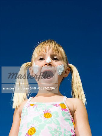 Boy and girl with sunscreen shouting
