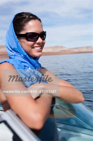 Woman on boat with headscarf and sunglasses