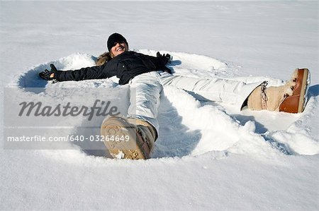 Woman making snow angel