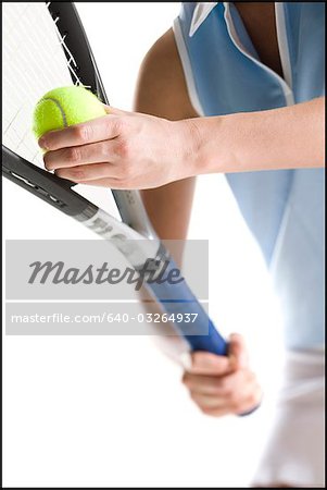 Close-up of tennis player serving ball