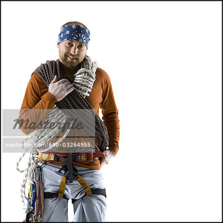 Man with rope and rock climbing belt