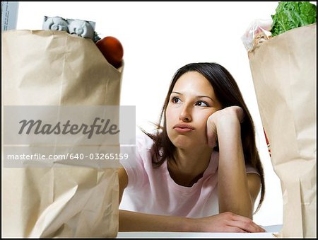 Woman in between two bags of groceries