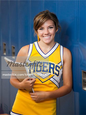 USA, Utah, Spanish Fork, Portrait of school girl (16-17) holding notepad by lockers