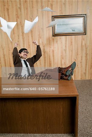 Successful businessman throwing paperwork in office