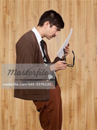 Businessman reading document in office
