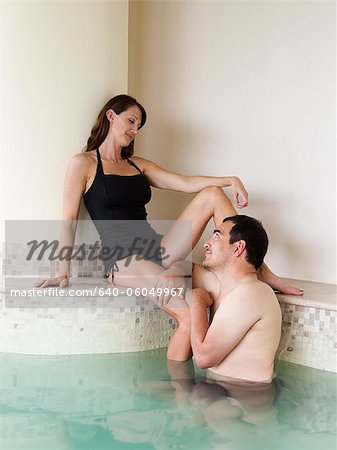 Italy, Tuscany, Couple relaxing in swimming pool