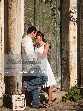 Italy, Ravello, Mature couple standing by old weathered door