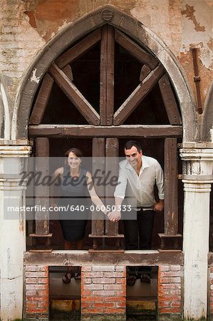 Italy, Venice, Couple standing in arcade