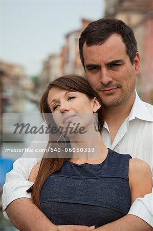 Italy, Venice, Romantic couple standing on bridge over canal