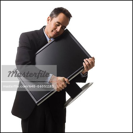 businessman holding a flat screen monitor