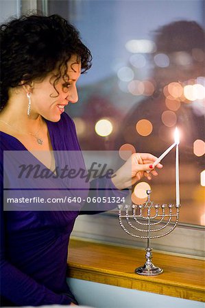 Woman lighting a menorah