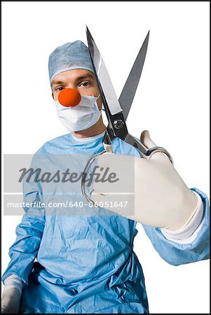surgeon wearing a creepy clown nose and holding scissors