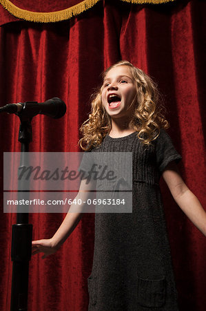 USA, Utah, Orem, Portrait of girl (8-9) singing with microphone