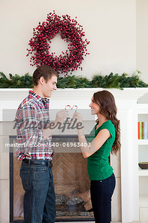 Smiling couple in room decorated for christmas