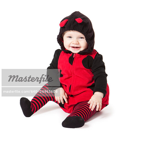 Portrait of baby girl (6-11 months) in ladybird costume for Halloween