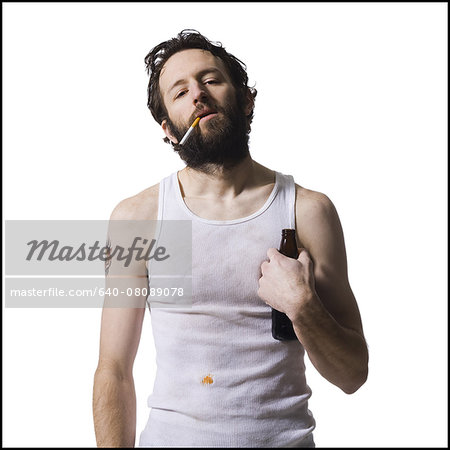 Disheveled man smoking cigarette with beer bottle