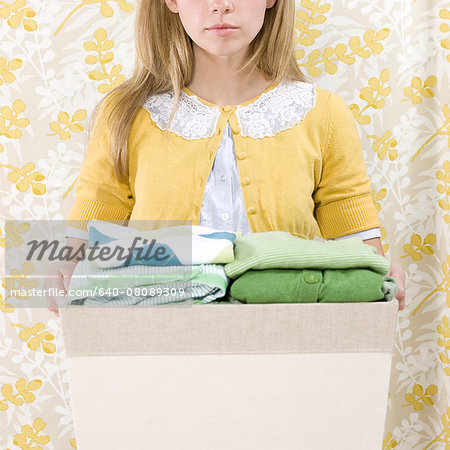 woman with a basket of folded clothes woman with a basket of folded clothes
