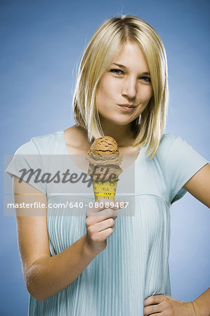 woman eating ice cream out of a tape measure cone