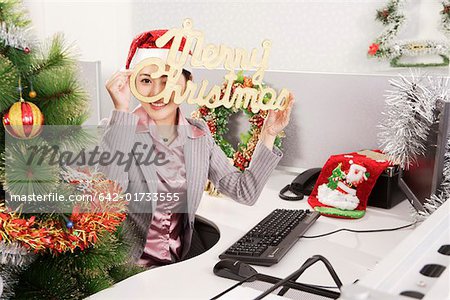 Office woman holding a sign of Merry Christmas on Christmas Day