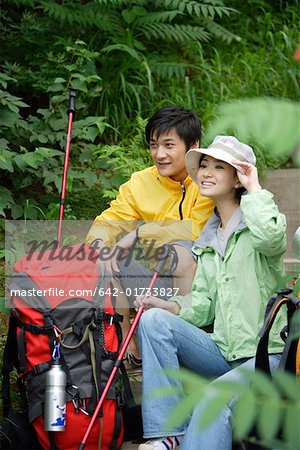 Young couple sitting together, smiling