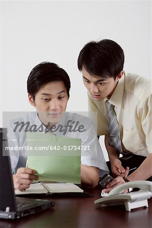 Businessmen looking at a paper