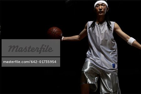 Basketball player dribbling ball