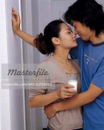 Young couple hugging to share milk