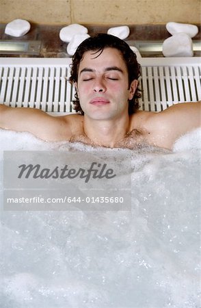 Young man  in jacuzzi at a spa