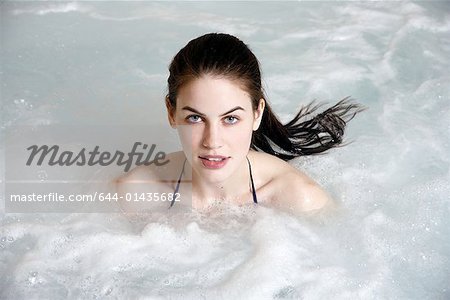 Young woman in jacuzzi at a spa