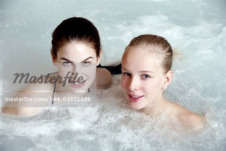 Two young woman in jacuzzi at a spa