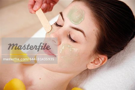 Woman having a facial treatment in a spa